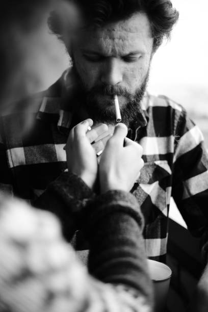 istock Man is lighting up friend's sigarette 1330648232