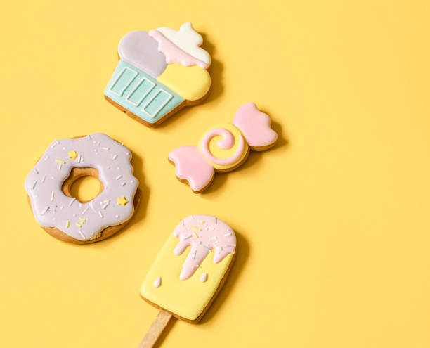 istock Colorful glazed gingerbread cookies on yellow background copy space. 1330650149