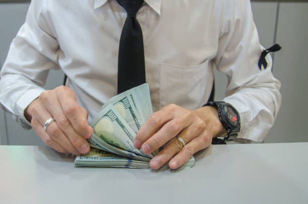 istock Businessman counting hundred dollar bills. 1330651384