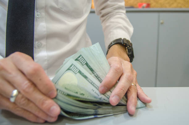 istock Businessman counting hundred dollar bills. 1330651405