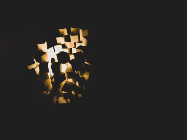istock Wooden cubes stack with light shines in the dark 1330652249