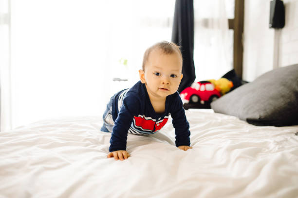istock asian cute baby crawling on the bed 1330653105