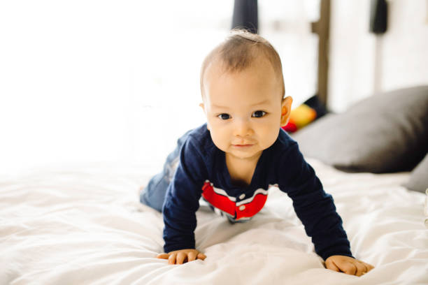 istock asian cute baby crawling on the bed 1330653108
