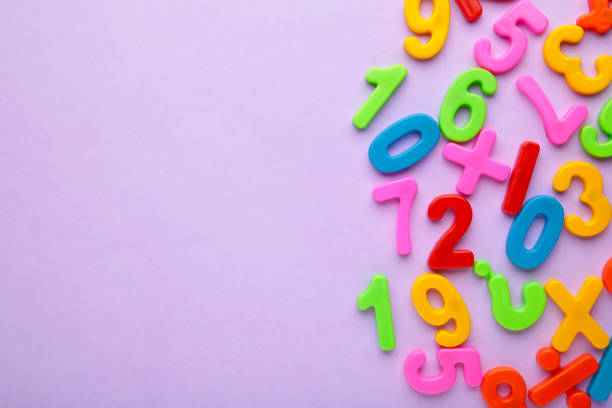 istock Magnetic multi-coloured figures on purple background with copy space. Back to school. 1330653395