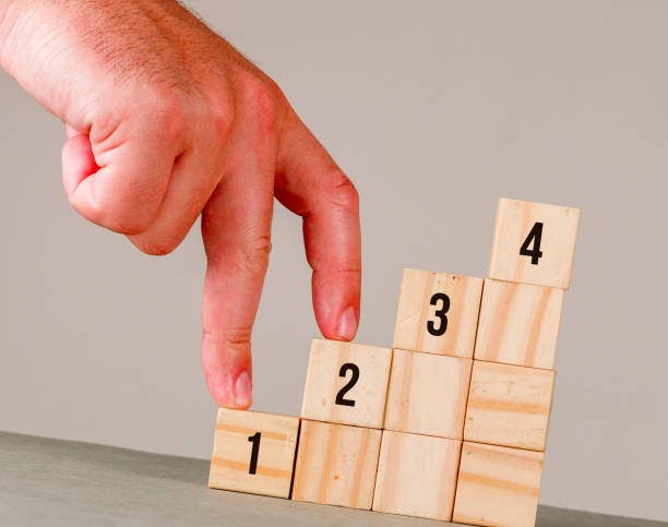 istock Business strategy concept on grey and white background side view. man putting fingers on step stairs. 1330658864