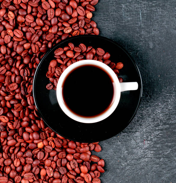 istock top view coffee cup and coffee beans on dark table 1330659203