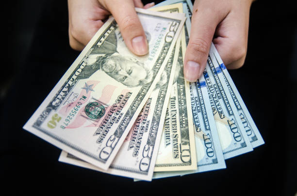 istock US dollar money paper on hand. 1330660299