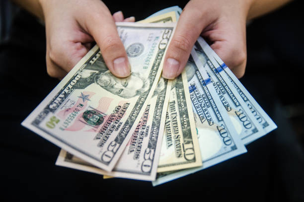 istock US dollar money paper on hand. 1330660300