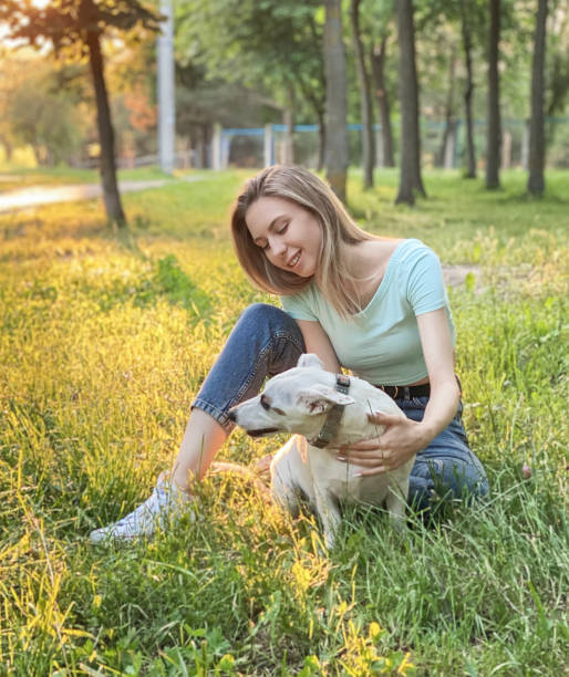 istock Woman playing with a dog 1330661473