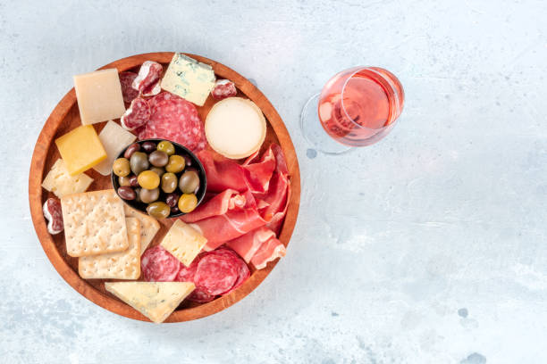 istock Charcuterie and cheese platter, overhead shot with rose wine 1330662103