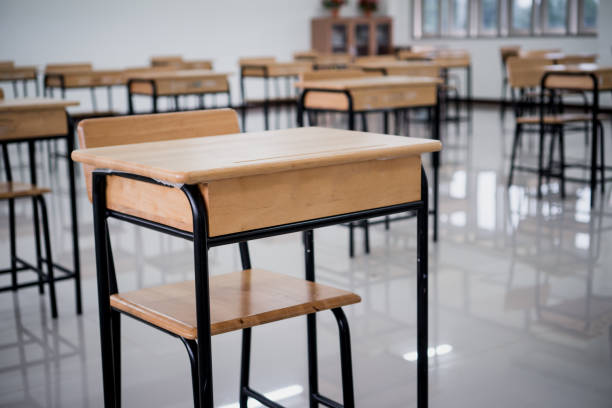 istock School empty classroom no childrens when COVID-19 disease outbreak and closed quarantine, no pupils in school and student study at home. Education learning problem in future and new normal life 1330667312