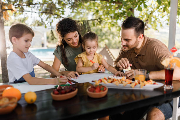 istock Happy family enjoying while coloring in the backyard. 1330668724