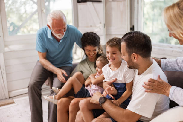 istock Playful extended family having fun on sofa at home. 1330668785
