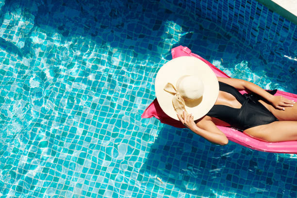 istock Woman Sunbathing on Floating Mattress 1330669666