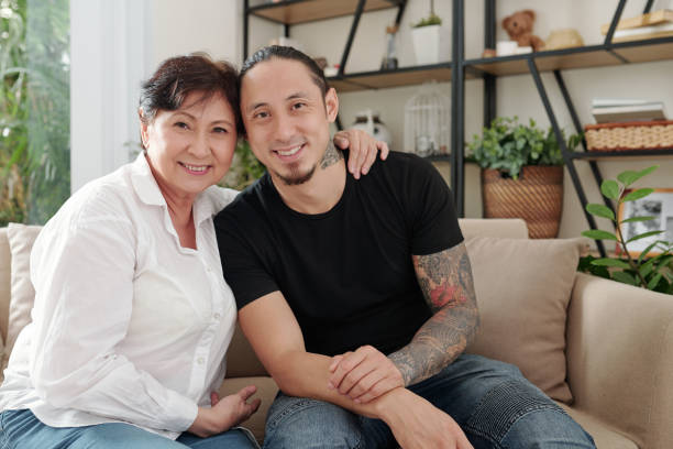 Mother with her elder son at home stock photo