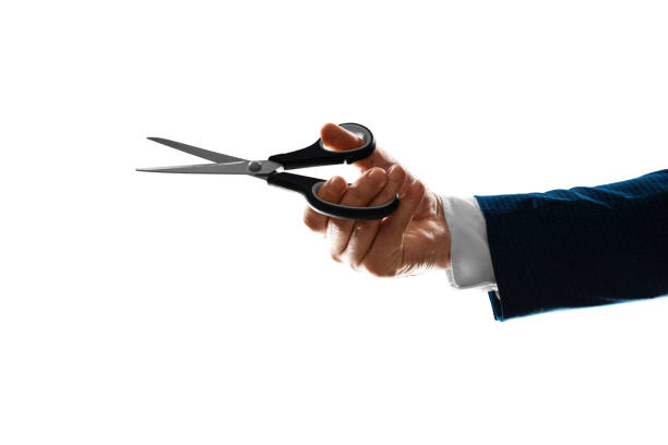 istock Male hand holding scissors isolated on white background, close-up. 1330673478