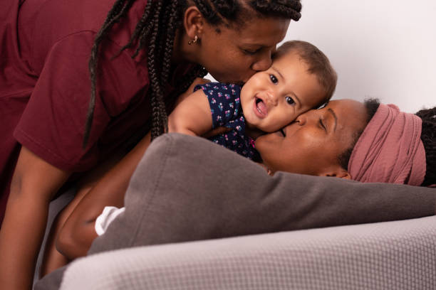 Homosexual lesbian family with one child. stock photo