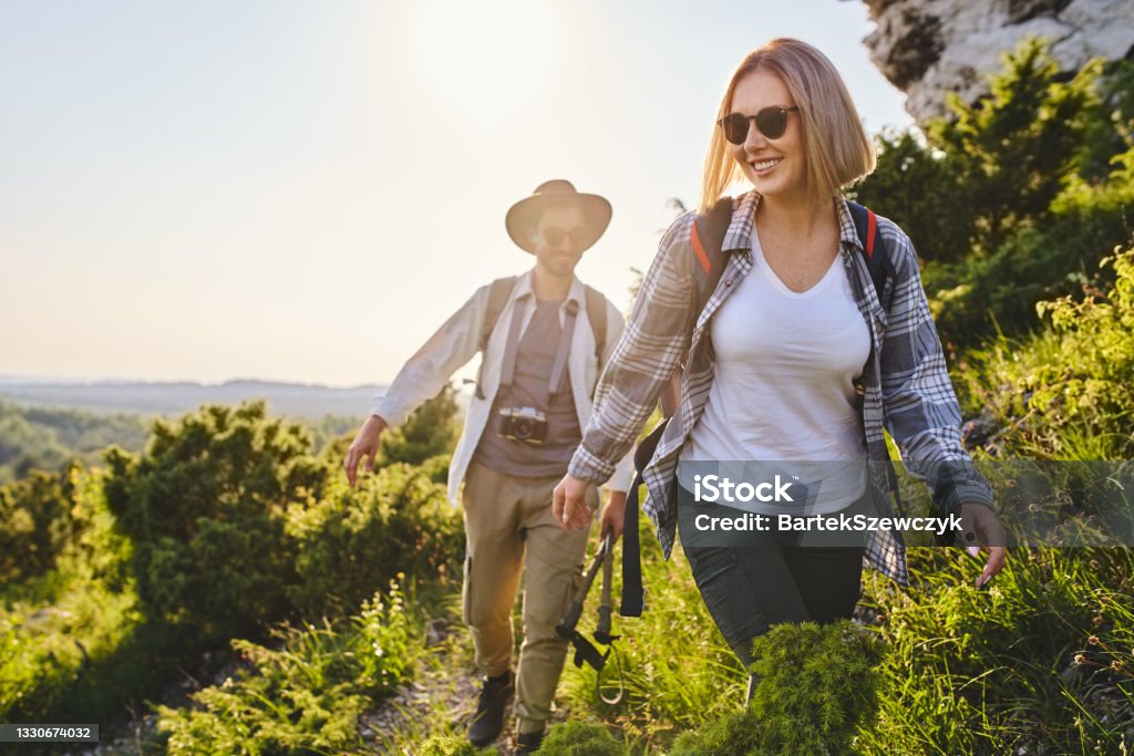 Happy couple hiking together in the mountains Hiking Stock Photo