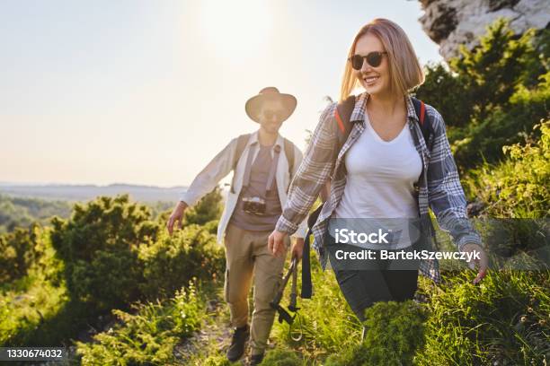 Happy Couple Hiking Together In The Mountains Stock Photo - Download Image Now - Hiking, Couple - Relationship, Vitality