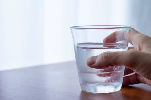 istock Hand holding a glass filled with cold water 1330674523