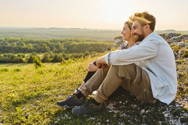 istock Young couple sitting together during summer hike 1330674527