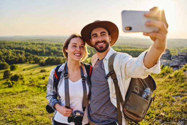 istock Smiling couple taking selfie while hiking together in the mountains 1330674637