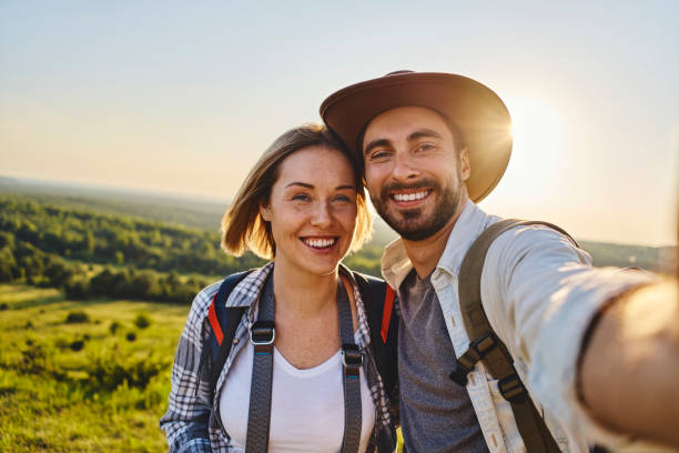 istock Happy couple taking selfie while hiking together in the mountains 1330674897