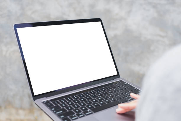 istock a woman holding and using laptop computer with blank white desktop screen in the outdoors 1330675340