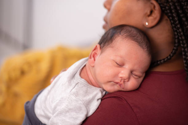 istock Baby laying on mother's shoulder. 1330675542