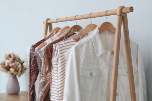 istock Rack with clothes in plastic bags indoors 1330675612