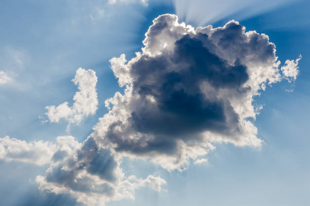 istock Sun beams from behind of cumulus cloud on a sky 1330675674