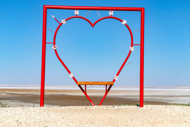 heart shaped bench. It was made for lovers to take pictures. salt lake view stock photo