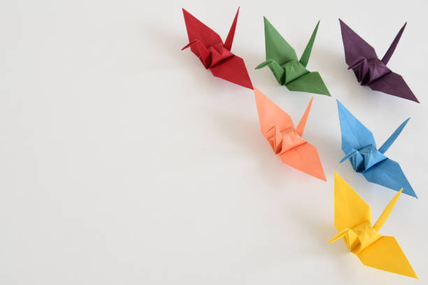 istock LGBT rainbow colored Origami paper cranes on white background. 1330676006