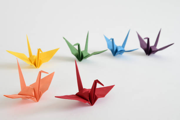 istock LGBT rainbow colored Origami paper cranes on white background. 1330676022