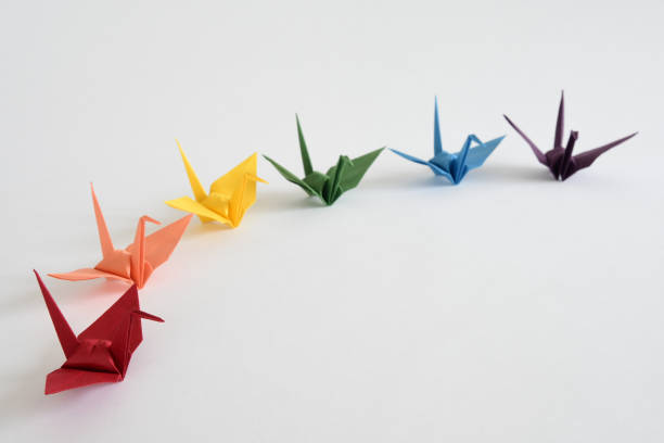 istock LGBT rainbow colored Origami paper cranes on white background. 1330676029