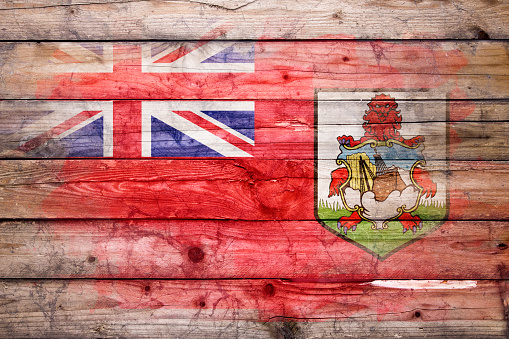 Flag of Bermuda watercolor painted on a old wooden boards. Grunge flags texture. Background concept. Full color. Horizontal orientation. Faded effect.