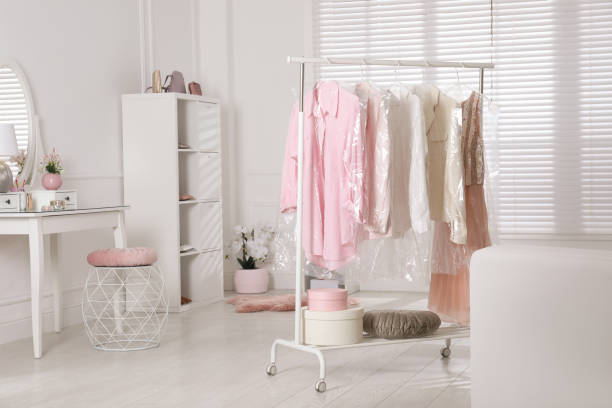 istock Rack with clothes in plastic bags indoors 1330676192