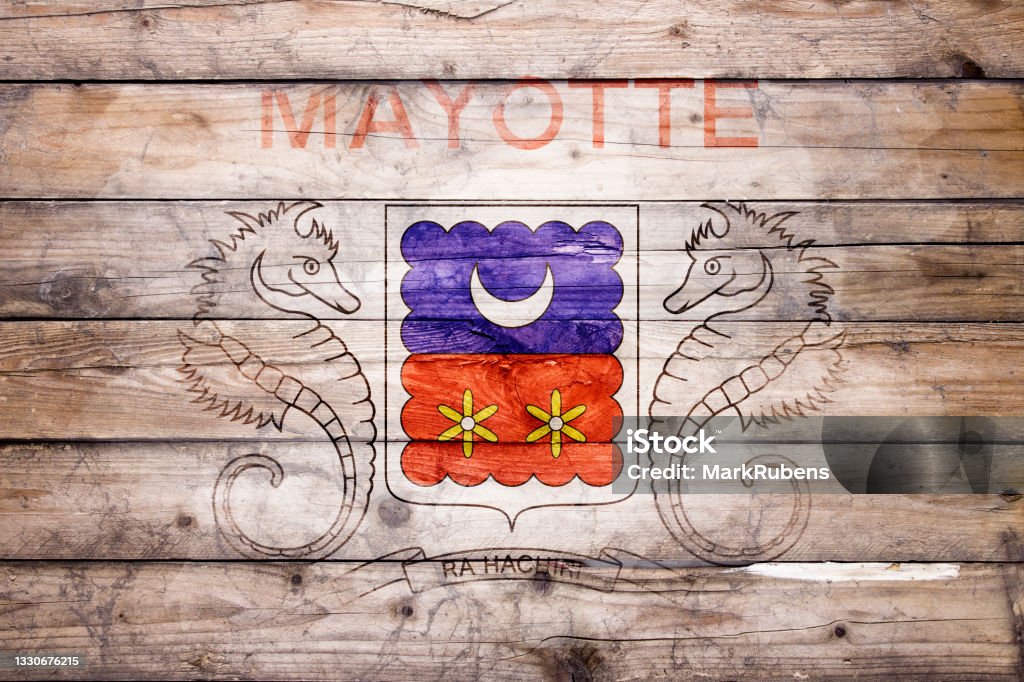 Flag of Mayotte on wooden boards Flag of Mayotte watercolor painted on a old wooden boards. Grunge flags texture. Background concept. Full color. Horizontal orientation. Faded effect. Mayotte Stock Photo