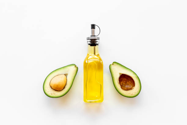 istock Avocado oil in glass bottle with fresh avocado 1330676259