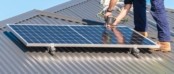 istock Unidentified man attaching solar panel to the roof rack 1330677104