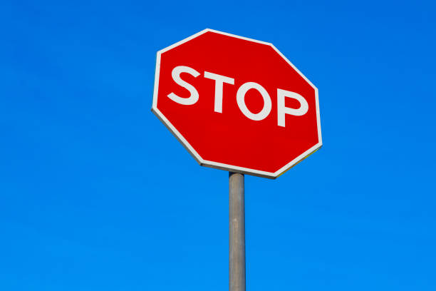 istock Red stop sign in city close up 1330677133