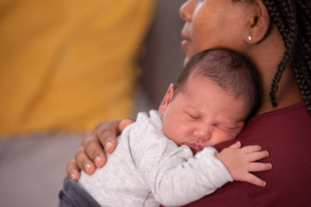 istock Baby laying on mother's shoulder. 1330677225