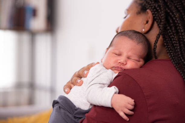 istock Baby laying on mother's shoulder. 1330677561