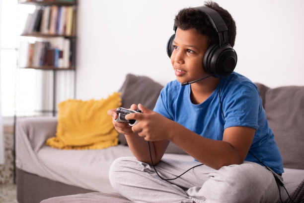 Boy playing a video game. stock photo