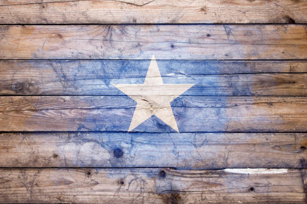Flag of Somalia watercolor painted on a old wooden boards. Grunge flags texture. Background concept. Full color. Horizontal orientation. Faded effect.