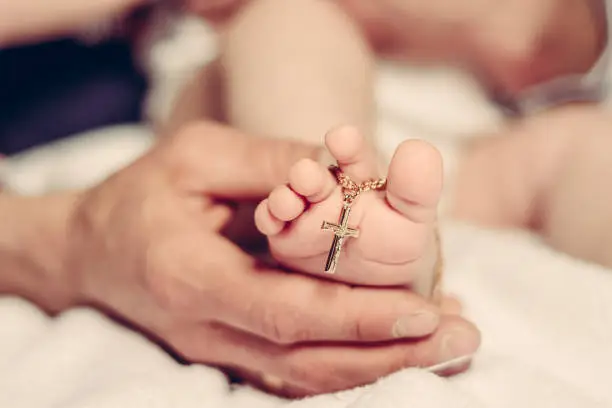 Baptism of a baby, close up of tiny baby feet, sacrament of baptism.2020
