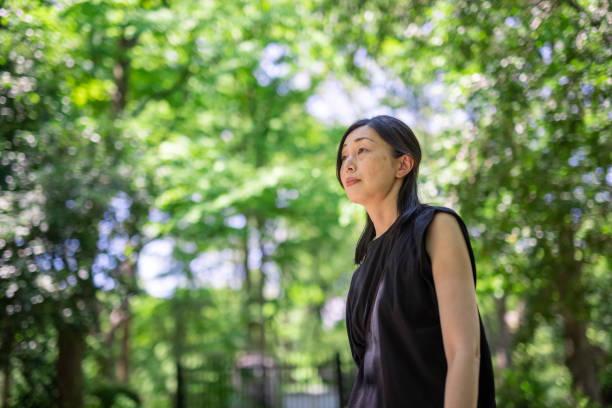 istock Japanese woman walking in public park 1330678547