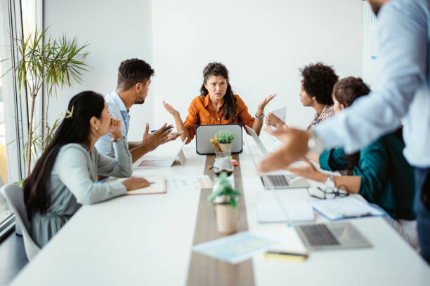 istock Multiracial business team group disputing in office boardroom 1330679515