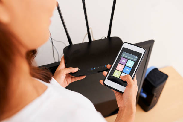 istock Woman Connecting to Wi-fi Router 1330679784