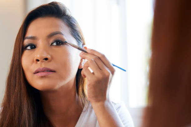 Concentrated Woman Applying Eye Shadows
